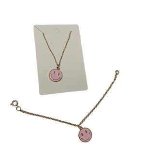 Pink and gold smiley face necklace and bracelet